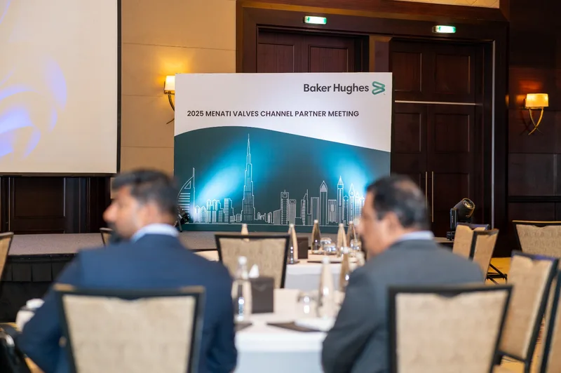 Stage backdrop reading 2025 MENATI Valves Channel Partner Meeting with a Dubai skyline