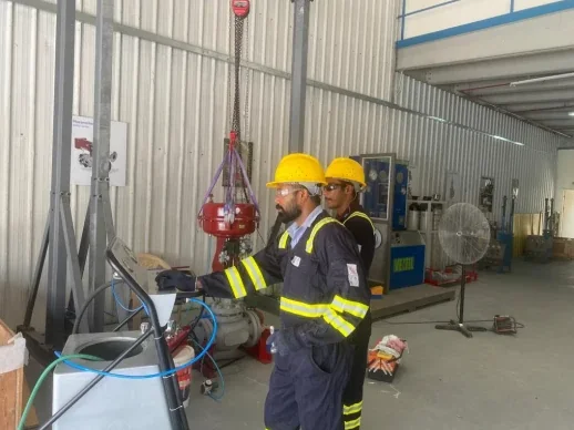 TMI technicians testing a control valve in the workshop